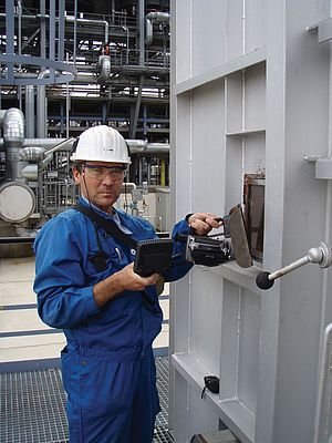 Holger Springer with his Flir infrared camera at a furnace inspection window