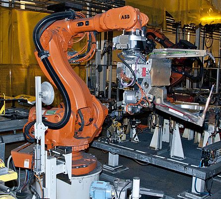 An RSP swivel tool changer STC350SWP with a spot welding gun on an ABB robot in operation at the floor assembly line of the Volvo C70