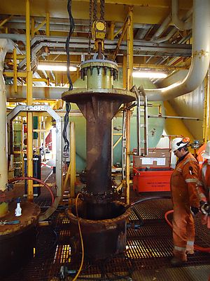 The start of dismantling seawater pumping equipment on an offshore rig utilising a J D Neuhaus air operated hoist.